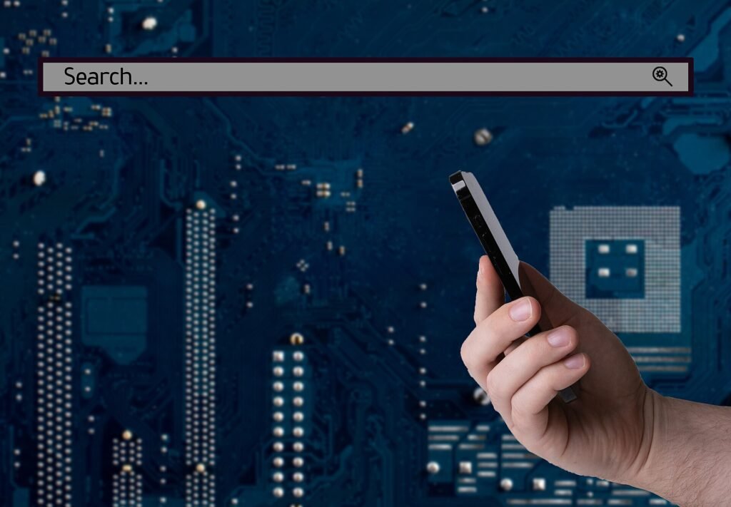 Hand holding a smartphone with a search bar on the screen