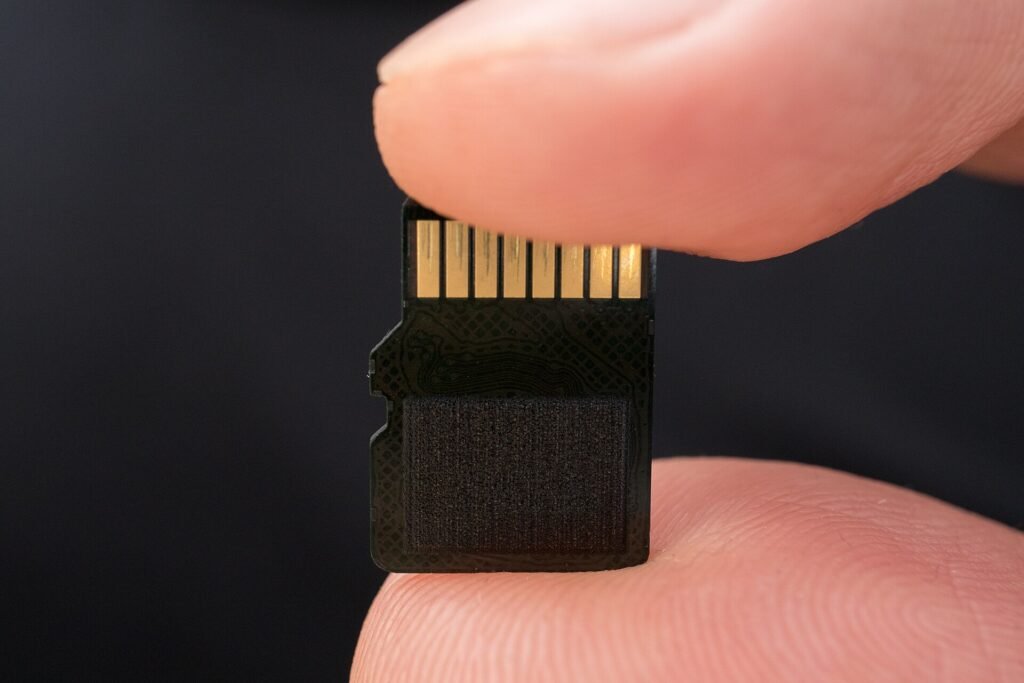 MicroSD card held between two fingers