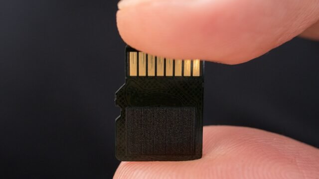 MicroSD card held between two fingers