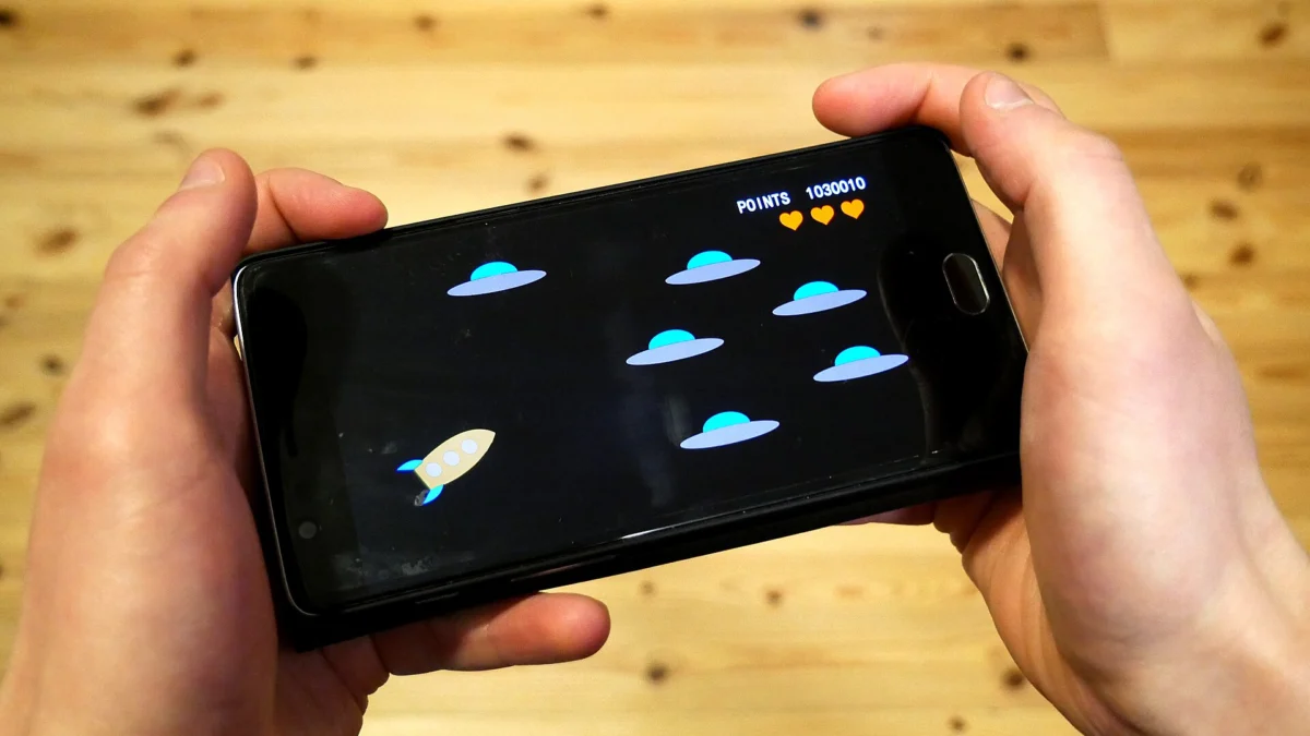 Person playing a video game on a smartphone