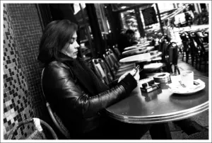 Person pausing from a smartphone, representing screen time limits
